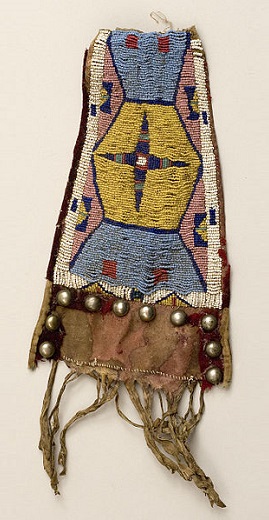 Decorative rawhide panel with glass, beads, red wool trade cloth, and silver conchos. Columbia Plateau.